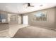 Versatile living room space featuring neutral flooring, a modern ceiling fan, and plenty of room for dining and living at 8795 W Windsor Dr, Peoria, AZ 85381