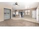 Open-concept living space with modern kitchen, stainless steel appliances, and stylish ceiling fan at 8795 W Windsor Dr, Peoria, AZ 85381
