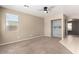 Bright living room featuring neutral paint, carpeting, and a closet with built-in shelving at 8795 W Windsor Dr, Peoria, AZ 85381