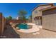 Backyard pool with rock features and patio area, perfect for outdoor relaxation and entertaining at 8795 W Windsor Dr, Peoria, AZ 85381