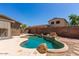 Backyard swimming pool surrounded by desert landscaping and a privacy fence at 8795 W Windsor Dr, Peoria, AZ 85381