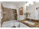 Bathroom with granite countertop, decorative backsplash, and updated fixtures at 9330 E Kalil Dr, Scottsdale, AZ 85260