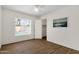 Bright bedroom with wood-look flooring and view of the pool through a window at 9330 E Kalil Dr, Scottsdale, AZ 85260