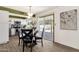 Dining area adjacent to kitchen, with sliding glass doors to backyard, and modern lighting fixture at 9330 E Kalil Dr, Scottsdale, AZ 85260