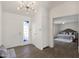 Bright foyer with a decorative glass front door, wood-look floors, and an open view to the main bedroom at 9330 E Kalil Dr, Scottsdale, AZ 85260