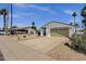 Well-kept single story home with a two-car garage, desert landscaping and an expansive driveway at 9330 E Kalil Dr, Scottsdale, AZ 85260