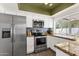 Updated kitchen with stainless steel appliances, granite countertops, mosaic backsplash, and ample natural light at 9330 E Kalil Dr, Scottsdale, AZ 85260