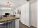 Open concept kitchen with stainless steel dishwasher and view into adjacent dining and living area at 9330 E Kalil Dr, Scottsdale, AZ 85260