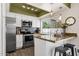 Kitchen with stainless steel appliances, granite countertops, mosaic backsplash, and natural lighting at 9330 E Kalil Dr, Scottsdale, AZ 85260