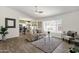 Bright living room featuring hardwood floors, a comfortable couch, and view into the kitchen and dining area at 9330 E Kalil Dr, Scottsdale, AZ 85260