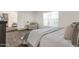 Main bedroom featuring wood-look floors, a comfortable chair and a sun-filled window with vertical blinds at 9330 E Kalil Dr, Scottsdale, AZ 85260