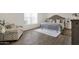 Comfortable main bedroom with light-filled window, seating area, a soft rug and wood-look flooring at 9330 E Kalil Dr, Scottsdale, AZ 85260