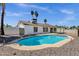 Back exterior view showcasing a well-maintained backyard swimming pool and covered patio with desert landscaping at 9330 E Kalil Dr, Scottsdale, AZ 85260
