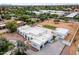 Expansive aerial view of a modern, white home with desert landscaping and a spacious backyard area at 9611 E Clinton St, Scottsdale, AZ 85260