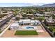 Elevated view shows a modern home with a backyard pool, spacious lawn, and an open layout for luxurious outdoor living at 9611 E Clinton St, Scottsdale, AZ 85260