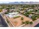 Aerial view showcases the modern home, pool, and surrounding desert landscape at 9611 E Clinton St, Scottsdale, AZ 85260