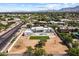 Expansive aerial view of modern house with mountain views and surrounding neighborhood at 9611 E Clinton St, Scottsdale, AZ 85260