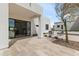 Inviting patio with tile flooring, an outdoor fireplace, and views into the home through sliding glass doors at 9611 E Clinton St, Scottsdale, AZ 85260