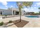Stunning backyard showcases a modern home with a refreshing pool and comfortable lounge area for outdoor relaxation at 9611 E Clinton St, Scottsdale, AZ 85260