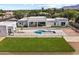 Aerial view of a home's backyard featuring a modern pool, a grassy area, and a sleek outdoor space at 9611 E Clinton St, Scottsdale, AZ 85260