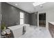 Modern bathroom with freestanding tub, glass shower, marble floors, and walk-in closet at 9611 E Clinton St, Scottsdale, AZ 85260