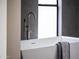 Contemporary bathroom showcasing a sleek soaking tub with modern fixtures and a soft-colored towel at 9611 E Clinton St, Scottsdale, AZ 85260