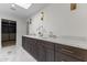 Bathroom with double sink vanity, sconces, walk-in closet, and marble floors at 9611 E Clinton St, Scottsdale, AZ 85260