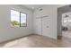 Hardwood bedroom with a window and closet, seamlessly connecting to the living area for a modern, open feel at 9611 E Clinton St, Scottsdale, AZ 85260