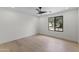 Bright, empty bedroom with light wood floors and a window at 9611 E Clinton St, Scottsdale, AZ 85260