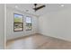 A spacious bedroom featuring hardwood floors, dual windows, and neutral wall color at 9611 E Clinton St, Scottsdale, AZ 85260