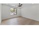 Bright bedroom featuring hardwood floors, a large window, and neutral wall color at 9611 E Clinton St, Scottsdale, AZ 85260