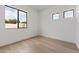 Bright bedroom features hardwood floors, a large window, and fresh white walls at 9611 E Clinton St, Scottsdale, AZ 85260