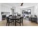 Bright and airy dining area with a modern table, sleek cabinets, and sliding glass doors to the outdoor pool and living area at 9611 E Clinton St, Scottsdale, AZ 85260