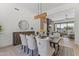 Elegant dining area with modern chandelier and views of the living room at 9611 E Clinton St, Scottsdale, AZ 85260