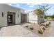 Inviting front entrance with stone pathway, desert landscaping, and a modern glass door at 9611 E Clinton St, Scottsdale, AZ 85260