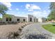 Spacious front yard with a paver driveway and desert landscaping leading to the modern home at 9611 E Clinton St, Scottsdale, AZ 85260