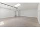Large, open garage featuring epoxy flooring and ample space for storage at 9611 E Clinton St, Scottsdale, AZ 85260