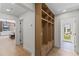 Hallway featuring built-in wooden storage cabinet and a view into the adjacent living room and backyard at 9611 E Clinton St, Scottsdale, AZ 85260