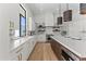 Well-lit kitchen showcasing custom cabinets, a large window, and modern fixtures at 9611 E Clinton St, Scottsdale, AZ 85260
