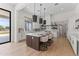 Bright kitchen featuring an island with seating, pendant lights, and marble countertops at 9611 E Clinton St, Scottsdale, AZ 85260