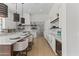 Open kitchen boasts a large island with seating, wine fridge, and marble backsplash at 9611 E Clinton St, Scottsdale, AZ 85260
