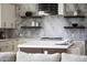 Elegant kitchen with a large island, stylish pendant lights, and marble backsplash at 9611 E Clinton St, Scottsdale, AZ 85260
