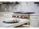 A modern stainless steel stove with a white marble backsplash at 9611 E Clinton St, Scottsdale, AZ 85260