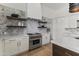 Modern kitchen design with stainless steel stove, marble accents, and floating shelves at 9611 E Clinton St, Scottsdale, AZ 85260