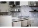 Kitchen island with a marble backsplash and chairs for dining at 9611 E Clinton St, Scottsdale, AZ 85260