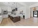 Spacious kitchen with a large island, stainless steel appliances, and modern lighting at 9611 E Clinton St, Scottsdale, AZ 85260