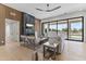 Bright living room featuring a modern fireplace, wood accent wall, and sliding glass doors at 9611 E Clinton St, Scottsdale, AZ 85260