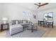 Open-concept living room with hardwood floors, a gray sectional sofa, and modern décor at 9611 E Clinton St, Scottsdale, AZ 85260