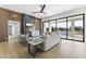 Contemporary living room with fireplace, wood paneled accent wall and large sliding glass doors at 9611 E Clinton St, Scottsdale, AZ 85260