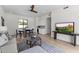 Open-concept living area with hardwood floors, a ceiling fan, a dining area, and a built-in bar with a wine cooler at 9611 E Clinton St, Scottsdale, AZ 85260